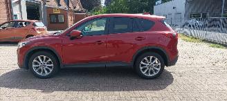 Unfallwagen Mazda CX-5 2.2 175pk Automatik 4x4 Navigatie Xenon Climatecontrol CruiseControl Stoelverwarming Lichtautomaat Privacyglas Regensensor Achteruitrijcamera Keyless entry 2014/7
